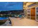 Enjoy mountain views from this spacious tiled patio with a conversation set and a nearby hot tub at 1228 Stellar Rim Ct, Henderson, NV 89012