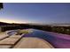 An infinity pool blends into the horizon, offering breathtaking views of the city skyline at sunset at 1228 Stellar Rim Ct, Henderson, NV 89012