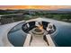 Incredible outdoor view of a fire pit surrounded by a pool and overlooking a city and mountain view at 1228 Stellar Rim Ct, Henderson, NV 89012