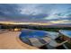 Relax in this zero-edge pool and hot tub with luxurious lounge chairs and city views at 1228 Stellar Rim Ct, Henderson, NV 89012