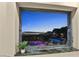 The window frames stunning views of the pool and the city skyline, offering a luxurious living experience at 1228 Stellar Rim Ct, Henderson, NV 89012