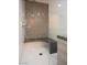 Luxurious walk-in shower featuring a built-in bench and intricate tile work at 1228 Stellar Rim Ct, Henderson, NV 89012