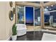 Comfortable sitting area with floor-to-ceiling windows offering stunning views of the pool and city skyline at 1228 Stellar Rim Ct, Henderson, NV 89012