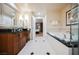 Bright bathroom featuring a soaking tub, dual sink vanity, and an open doorway to the bedroom at 135 Harmon Ave # 3220, Las Vegas, NV 89109