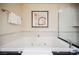 Bright bathroom with a soaking tub featuring jets with a dark countertop and glass enclosed shower at 135 Harmon Ave # 3220, Las Vegas, NV 89109