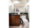 Well-lit bathroom with a dark vanity, large mirror, decorative sconces, and essential toiletries for a comfortable stay at 135 Harmon Ave # 3220, Las Vegas, NV 89109