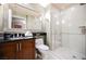Bathroom with a large vanity, framed mirror, and a walk-in shower featuring tiled walls and a glass door at 135 Harmon Ave # 3220, Las Vegas, NV 89109