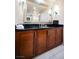 Bathroom vanity featuring a dark countertop with wood cabinets and a large mirror at 135 Harmon Ave # 3220, Las Vegas, NV 89109
