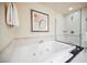 Bright bathroom with a soaking tub and glass enclosed shower and towel rack at 135 Harmon Ave # 3220, Las Vegas, NV 89109