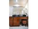 Bathroom vanity with dark countertop, wood cabinets, and decorative mirror at 135 Harmon Ave # 3220, Las Vegas, NV 89109