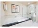 Elegant bathroom featuring a deep soaking tub and glass shower at 135 Harmon Ave # 3220, Las Vegas, NV 89109