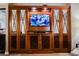 This is a large built-in entertainment center with paneled doors, a tv, and inset mirrors at 135 Harmon Ave # 3220, Las Vegas, NV 89109