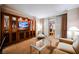Elegant living area with large TV, comfortable seating, and access to a balcony with sheer and patterned curtains at 135 Harmon Ave # 3220, Las Vegas, NV 89109
