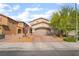 Inviting two-story home featuring a neutral color scheme, two-car garage, and charming desert landscaping at 162 Sand Lake St, Henderson, NV 89074