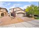 Attractive two-story home featuring desert landscaping, a two-car garage, and a welcoming entryway at 162 Sand Lake St, Henderson, NV 89074