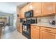 Charming kitchen with stainless appliances, wood cabinets and a view into the dining area at 162 Sand Lake St, Henderson, NV 89074