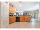 Bright kitchen boasts tile flooring, wood cabinetry, and stainless appliances, open to dining area at 162 Sand Lake St, Henderson, NV 89074