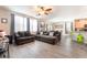 Bright living room featuring wood floors, neutral-toned walls, a gray sofa set, and abundant natural light at 162 Sand Lake St, Henderson, NV 89074