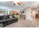 Open-concept living room featuring wood floors, a gray sofa set, a staircase, and modern fixtures at 162 Sand Lake St, Henderson, NV 89074