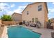 Backyard view of the refreshing pool with patio area, dining set, and egg chairs at 162 Sand Lake St, Henderson, NV 89074