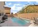 Backyard view of pool and patio area with egg chairs and privacy wall at 162 Sand Lake St, Henderson, NV 89074