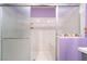 An enclosed shower featuring a built-in seat and marble-look surround at 162 Sand Lake St, Henderson, NV 89074