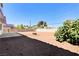 Large backyard featuring a concrete patio and ample space, enclosed by a sturdy wall, and desert landscaping at 1620 Yellow Rose St, Las Vegas, NV 89108
