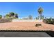 A large backyard with decorative firepit, privacy walls and desert landscaping at 1620 Yellow Rose St, Las Vegas, NV 89108