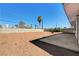 A large backyard with decorative firepit, privacy walls and desert landscaping at 1620 Yellow Rose St, Las Vegas, NV 89108