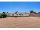 Spacious backyard with desert landscaping and block fence at 1620 Yellow Rose St, Las Vegas, NV 89108