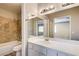 Bright bathroom with shower, bathtub and large mirror over the sink at 1620 Yellow Rose St, Las Vegas, NV 89108