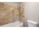 Bathroom with tile surround in shower/tub and neutral decor at 1620 Yellow Rose St, Las Vegas, NV 89108