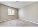 Cozy bedroom with plush carpeting, neutral walls, and a window with natural light at 1620 Yellow Rose St, Las Vegas, NV 89108