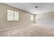 Large carpeted bedroom with two windows providing natural light and a comfortable atmosphere at 1620 Yellow Rose St, Las Vegas, NV 89108