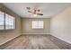 Spacious bedroom with ceiling fan, light walls, and wood-look flooring at 1620 Yellow Rose St, Las Vegas, NV 89108