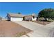 Single-story home with a two-car garage, desert landscaping, and a paved driveway at 1620 Yellow Rose St, Las Vegas, NV 89108