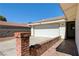 Attached two-car garage with a brick accent wall and a paved driveway at 1620 Yellow Rose St, Las Vegas, NV 89108