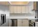 Close-up of the modern kitchen with stainless steel appliances, and white cabinets at 1620 Yellow Rose St, Las Vegas, NV 89108