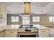 Kitchen island with smooth cooktop and range hood, ideal for entertaining and cooking at 1620 Yellow Rose St, Las Vegas, NV 89108