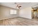 Spacious living room with modern ceiling fan and new wood-look flooring at 1620 Yellow Rose St, Las Vegas, NV 89108
