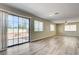 Open living room with sliding glass doors to backyard and modern wood flooring at 1620 Yellow Rose St, Las Vegas, NV 89108
