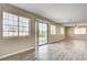 Living room featuring wood floors, large windows, and sliding glass doors to the backyard at 1620 Yellow Rose St, Las Vegas, NV 89108