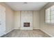 Living room featuring a tile-surround fireplace, neutral walls, and wood-look flooring at 1620 Yellow Rose St, Las Vegas, NV 89108