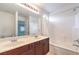 Bathroom featuring dual sinks, a large mirror, and a tub-shower combo at 170 Wicked Wedge Way, Las Vegas, NV 89148