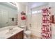 Clean bathroom with a shower-tub combo, vanity with storage, and decorative towels on the wall at 170 Wicked Wedge Way, Las Vegas, NV 89148
