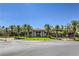 Beautiful community clubhouse featuring a porte cochere and lush tropical landscaping at 170 Wicked Wedge Way, Las Vegas, NV 89148