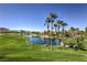 Scenic view of the golf course, a lake, and palm trees at 170 Wicked Wedge Way, Las Vegas, NV 89148