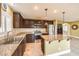 Well-lit kitchen features granite countertops, stainless steel appliances, and rich, dark cabinetry at 170 Wicked Wedge Way, Las Vegas, NV 89148