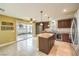 Spacious eat-in kitchen features granite countertops, stainless appliances, island, and sliding glass doors to the patio at 170 Wicked Wedge Way, Las Vegas, NV 89148