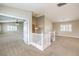 Open second-floor living area featuring neutral walls, carpet, white railing and natural light from the shuttered windows at 170 Wicked Wedge Way, Las Vegas, NV 89148